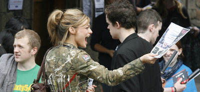 Girl handing out hype magazine