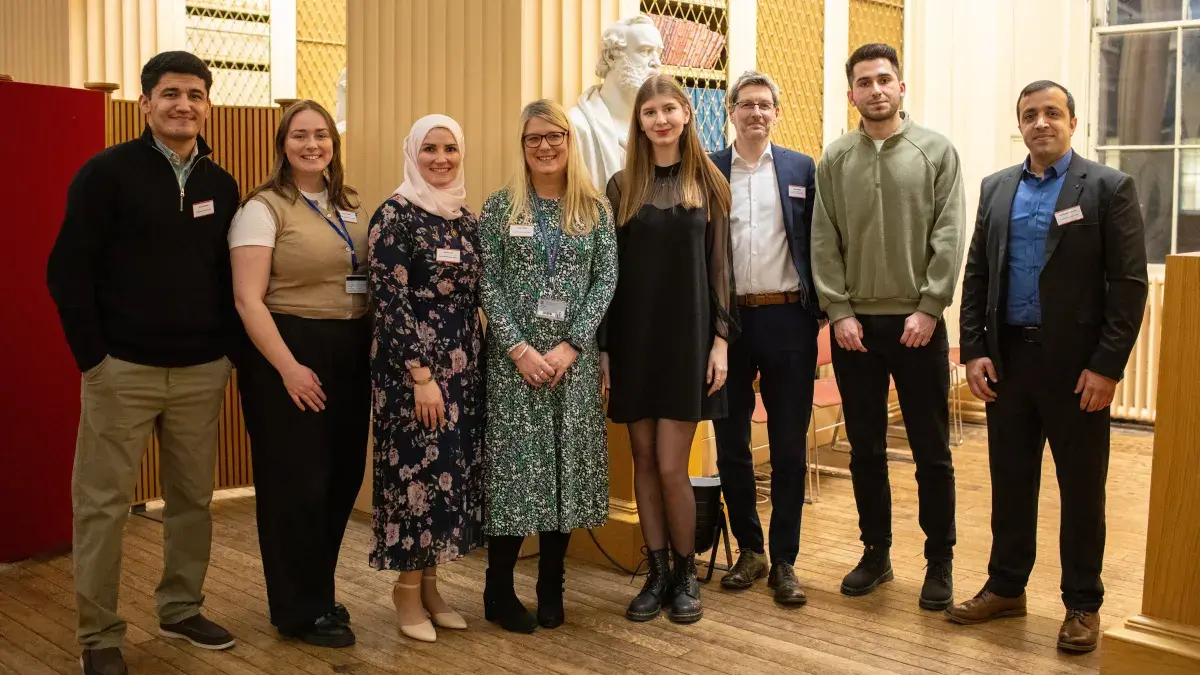 A group of students and university team members at the Education Beyond Borders celebration event.