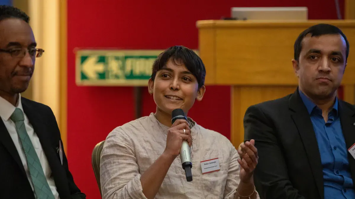 A student takes part in a discussion panel about Education Beyond Borders.