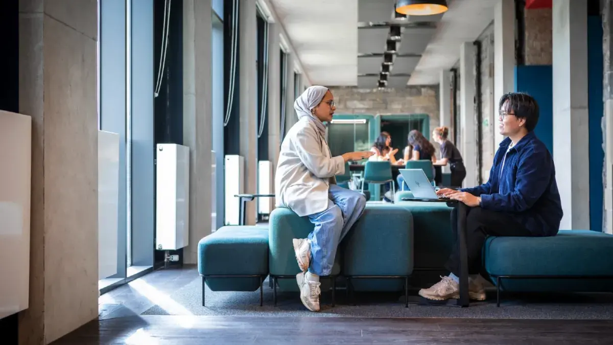 Two young people in conversation at the Edinburgh Futures Institute.