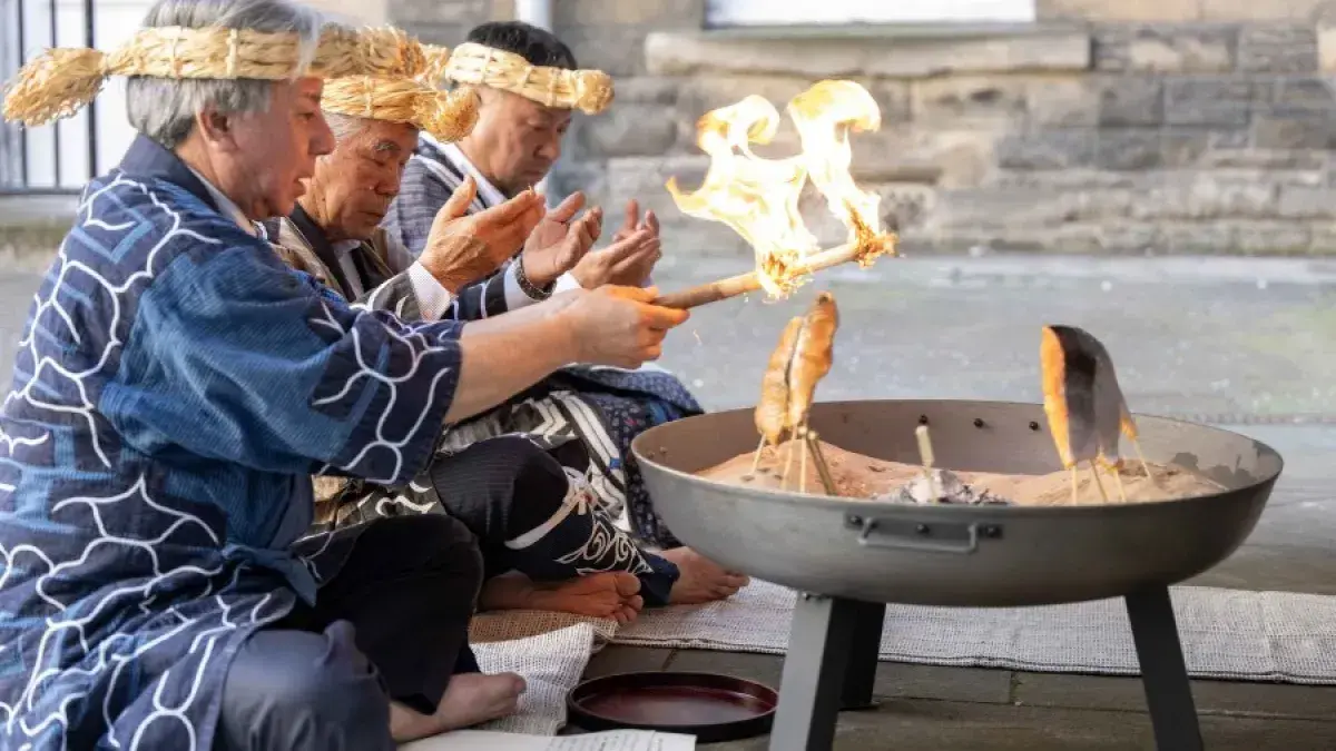 Representatives from the Ainu Association take part in a traditional ceremony outside