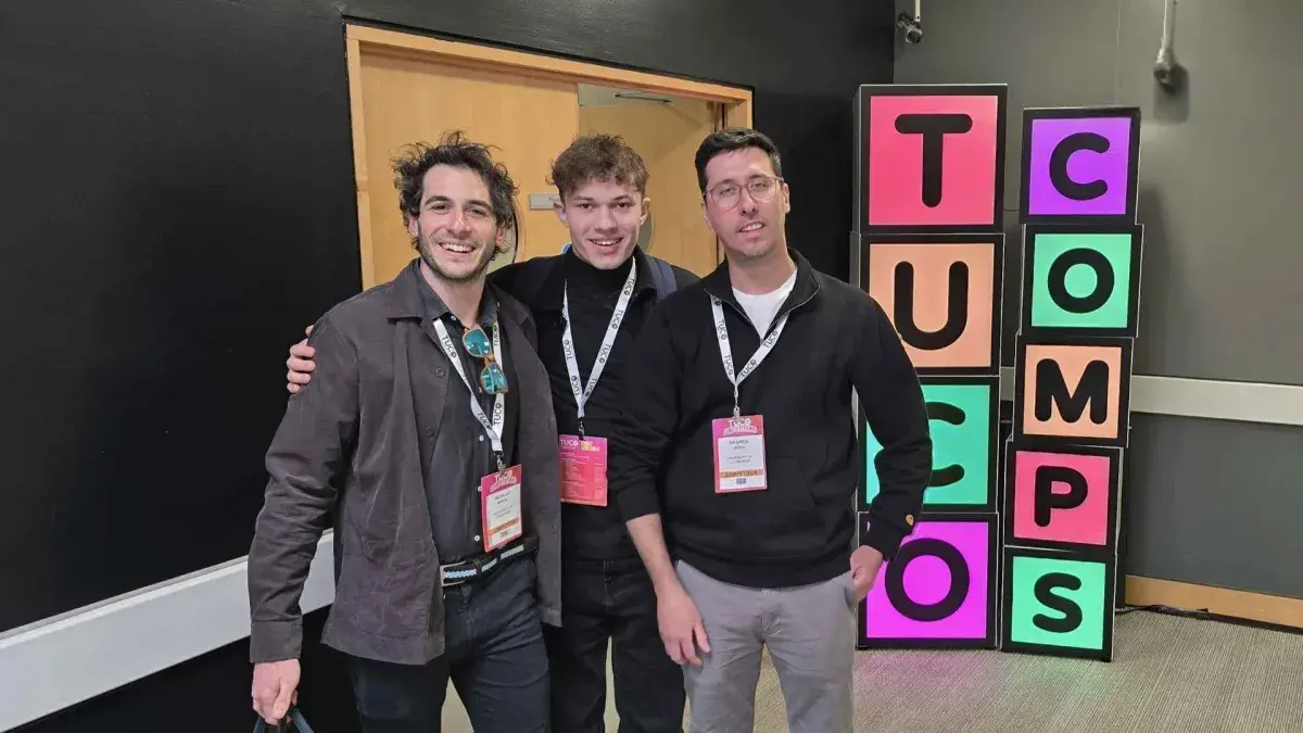 Three men pose for a photograph together at the TUCO 2025 competition.