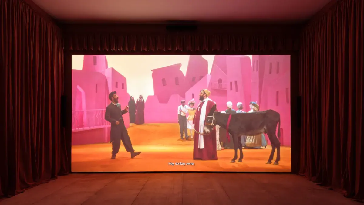 A still of a large-scale film installation playing inside a gallery space.