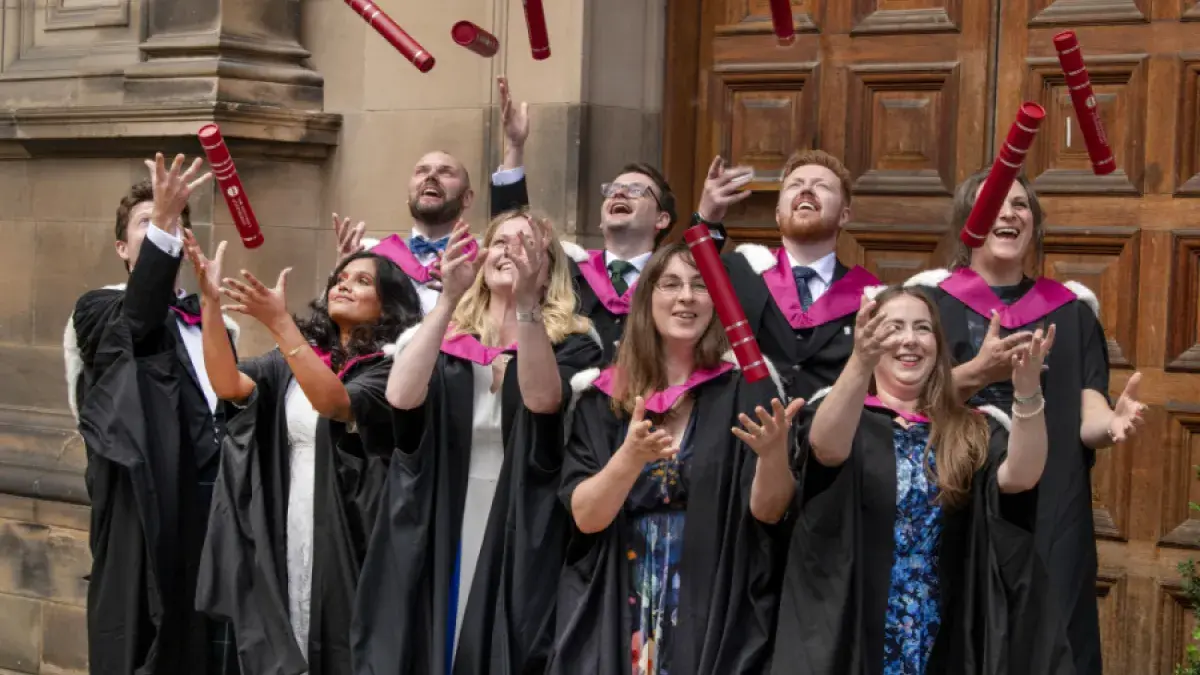 Graduates from the HCP-Med programme at the University of Edinburgh throw their degree certificate tubes into the air in front of McEwan Hall, Edinburgh