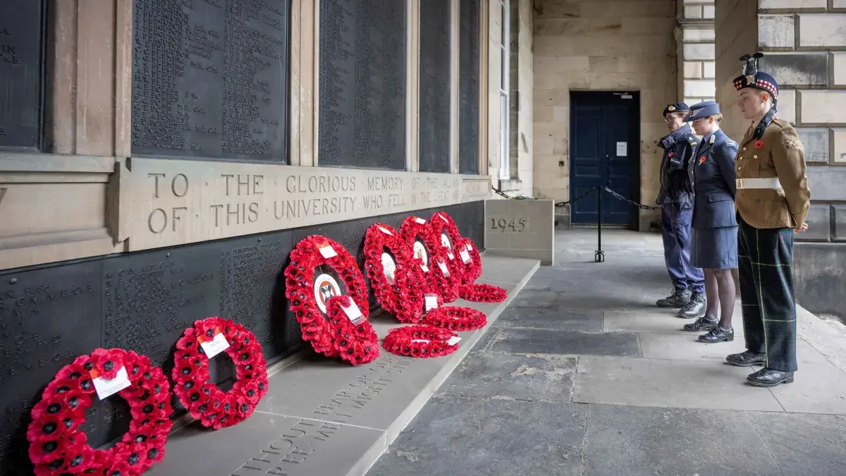 Members of the British Armed Forces pay respect at the War Memorial in the Old College Quadrangle, Edinburgh