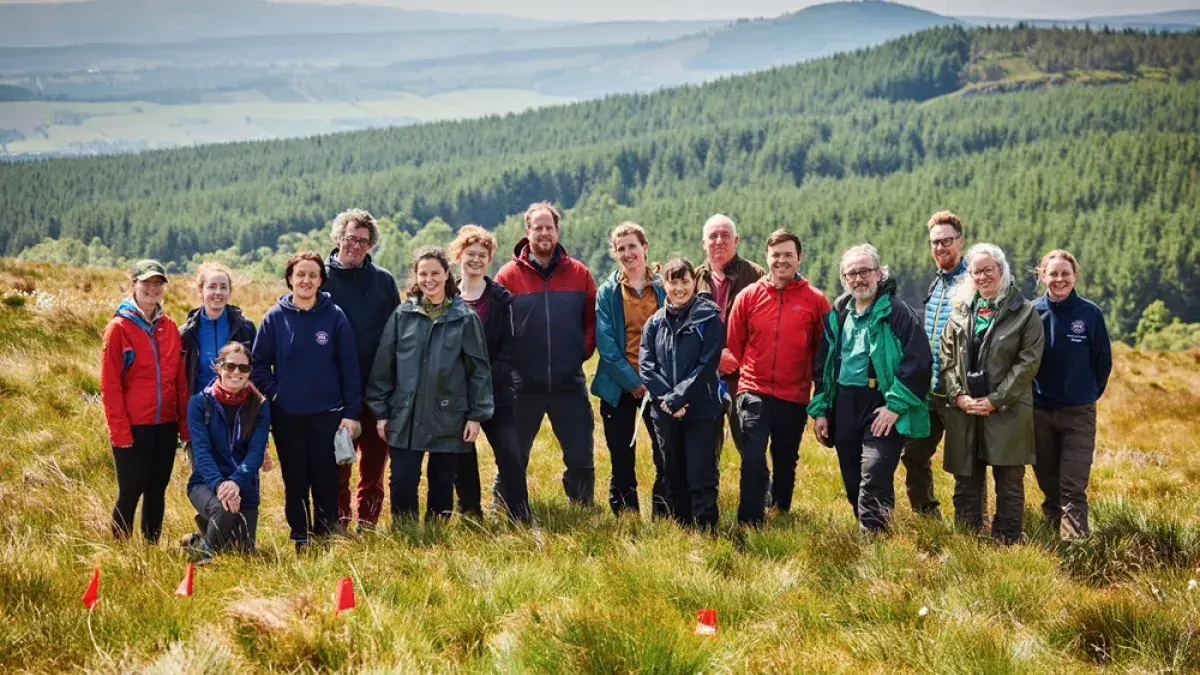 (L-R) Prof Caroline Nichol, Prof Marc Metzger, Rachel Orchard, Mareike Feldmann, Prof Rob Ogden, Tilda Tarrant, Dr Nicholle Bell, Dr Iain McNicol, Dr Georgios Xenakis, Dr Annie Yang standing on moorland at Drumbrae, Stirlingshire