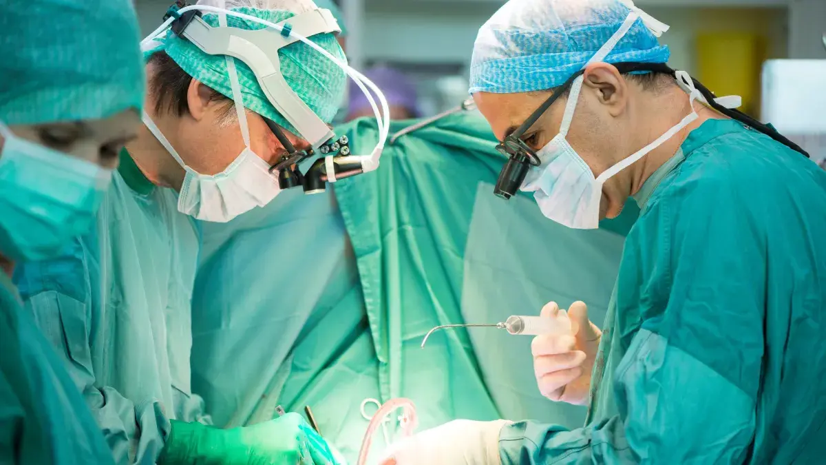 Heart surgeons during a heart operation, wearing scrubs