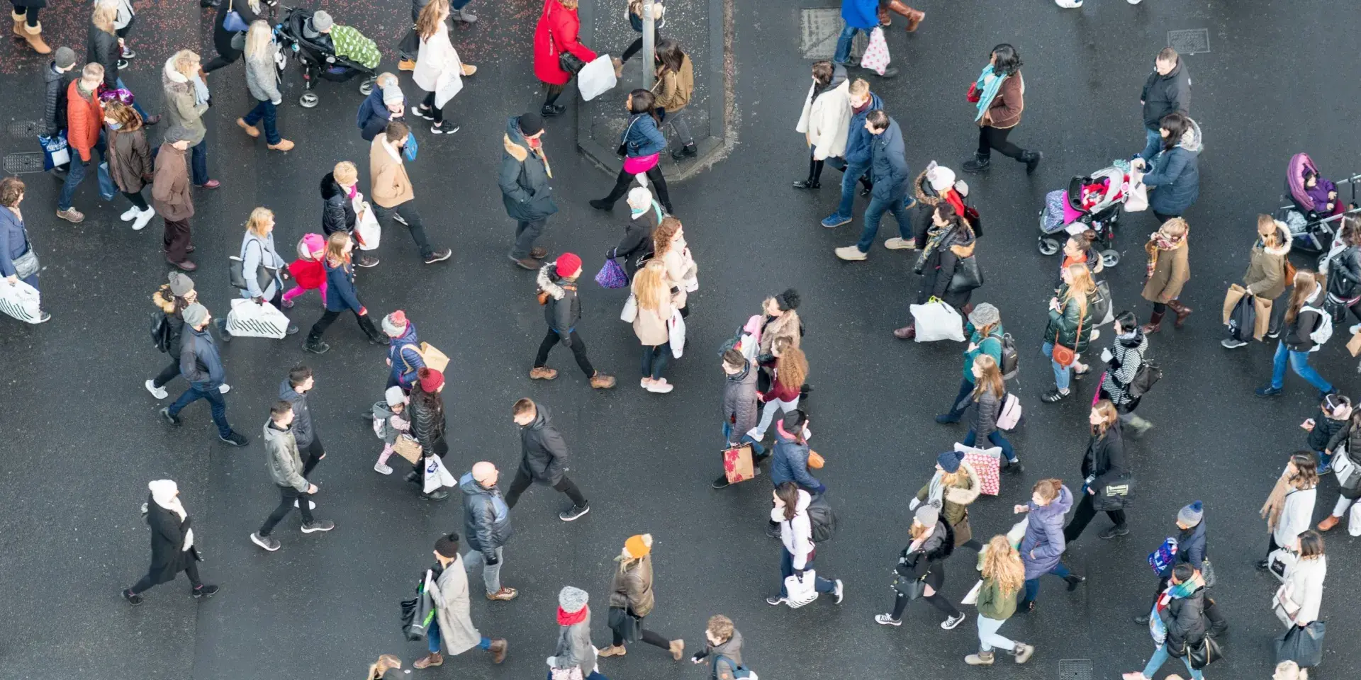 Aerial view of a crowd of pedestrians crossing a street in central Edinburgh