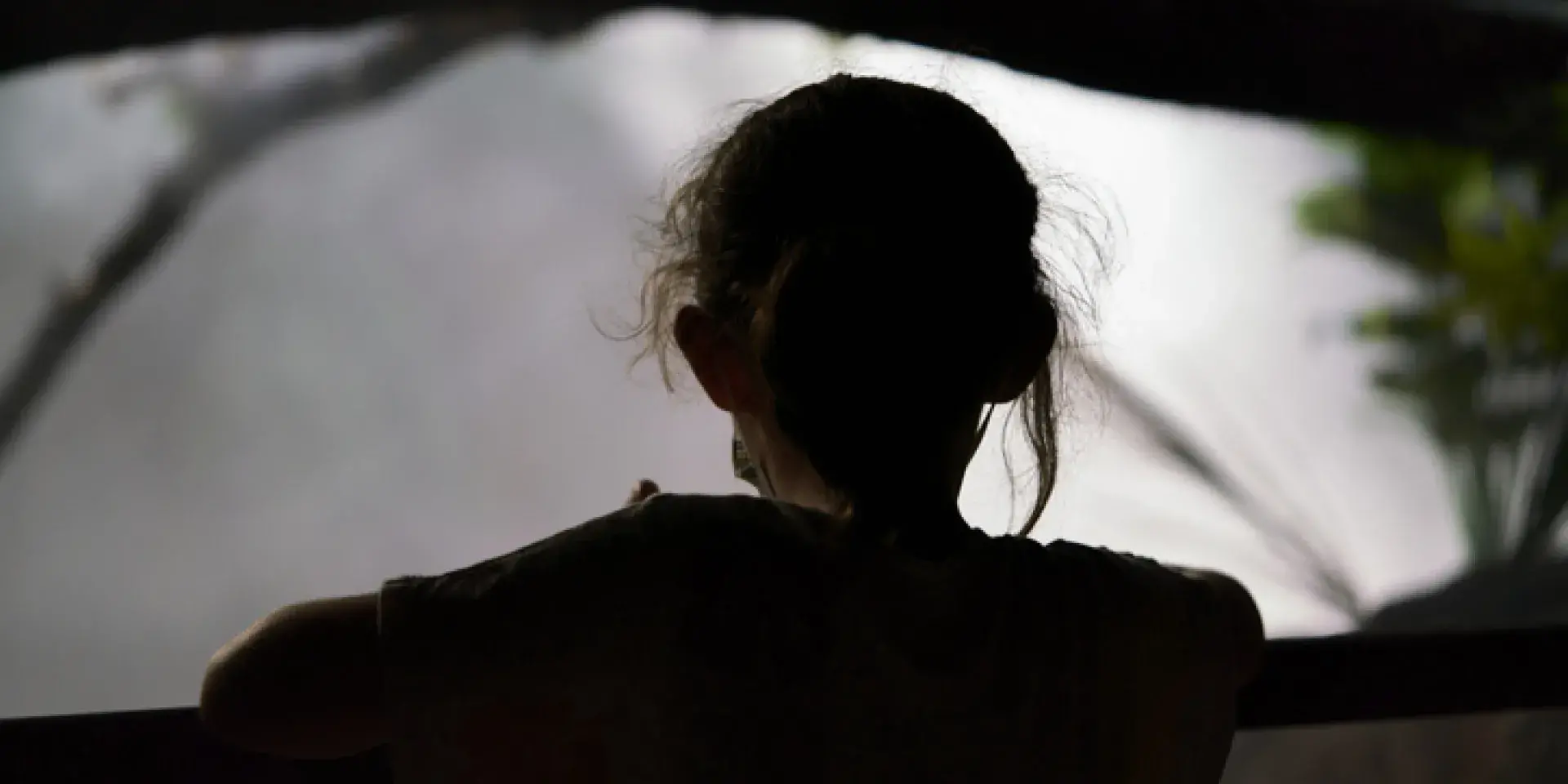 Grey silhouette of a young child against a grey background