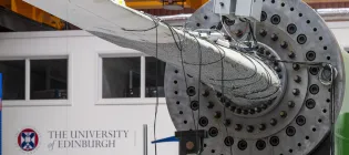 An image of a tidal turbine blade at the FastBlade testing facility, with the University of Edinburgh logo in the background