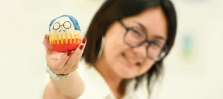 Image of ECA graduating student Tiana Sung with a figure