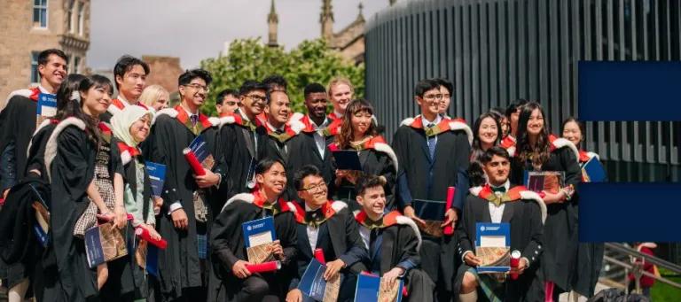 A group of graduates smiling for a photograph.