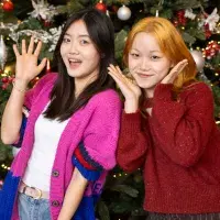 Students pose in front of Christmas Tree