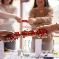 Students holding christmas crackers