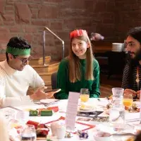 Students sit around a table at Festive Lunch