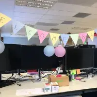 Bunting hung above an office desk displays the words 'Welcome Back'