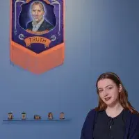 A student artist poses in front of their installation. 