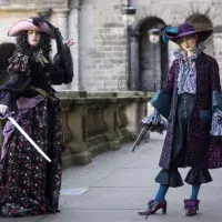 Two students pose in Their Performance Costume 2025 outfits for a photocall in Old College Quad. (L-R) Jean-Benoit Aubery from Daphne Du Maurier’s 1941 romantic adventure novel, Frenchman’s Creek and Barbara, the heroine of historical novel, Life and Death of the Wicked Lady Skelton 