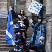 Two students pose in Their Performance Costume 2025 outfits for a photocall in Old College Quad. (L-R) Costume inspired by the Commonwealth Games in Glasgow and Mr Mole from The Wind in the Willows