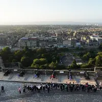 A view of the procession through the castle with the city in the background