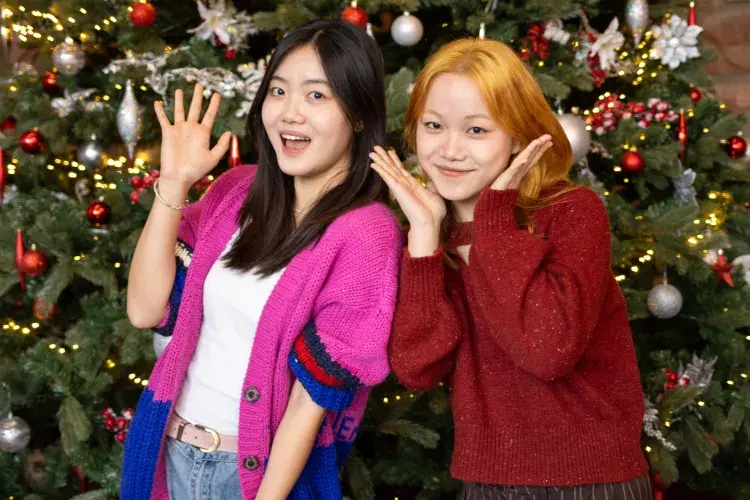 Students pose in front of Christmas Tree