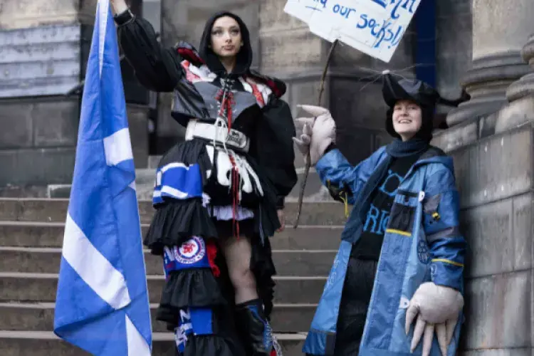Two students pose in Their Performance Costume 2025 outfits for a photocall in Old College Quad. (L-R) Costume inspired by the Commonwealth Games in Glasgow and Mr Mole from The Wind in the Willows