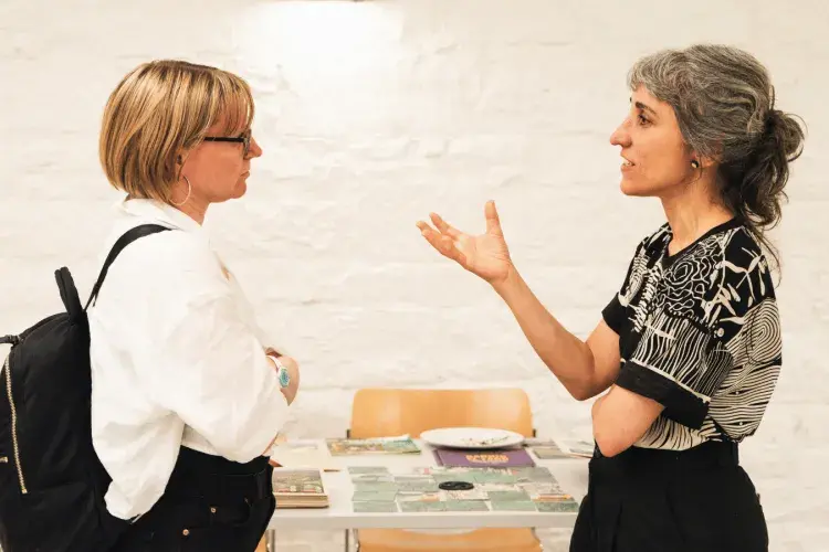 Colleagues talking at the Impact Festival