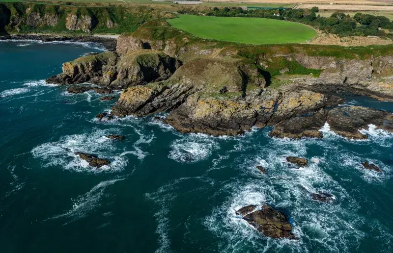 Aerial shot of coastal route on the North East of Scotland