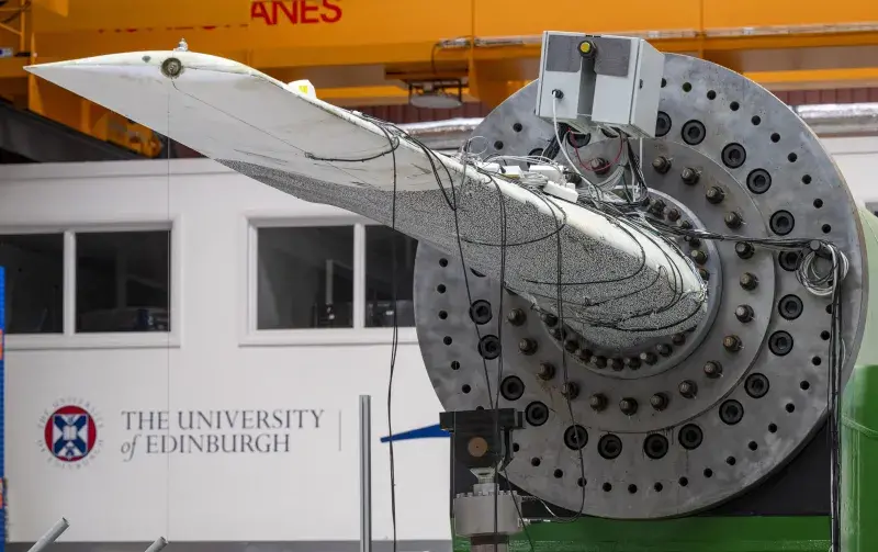 An image of a tidal turbine blade at the FastBlade testing facility, with the University of Edinburgh logo in the background