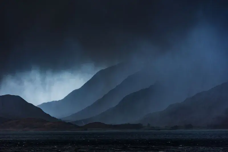 Dark rain clouds over a Scottish mountain range