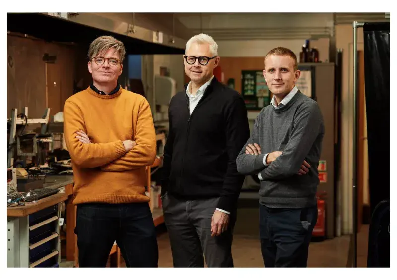 Three professors standing in fire lab